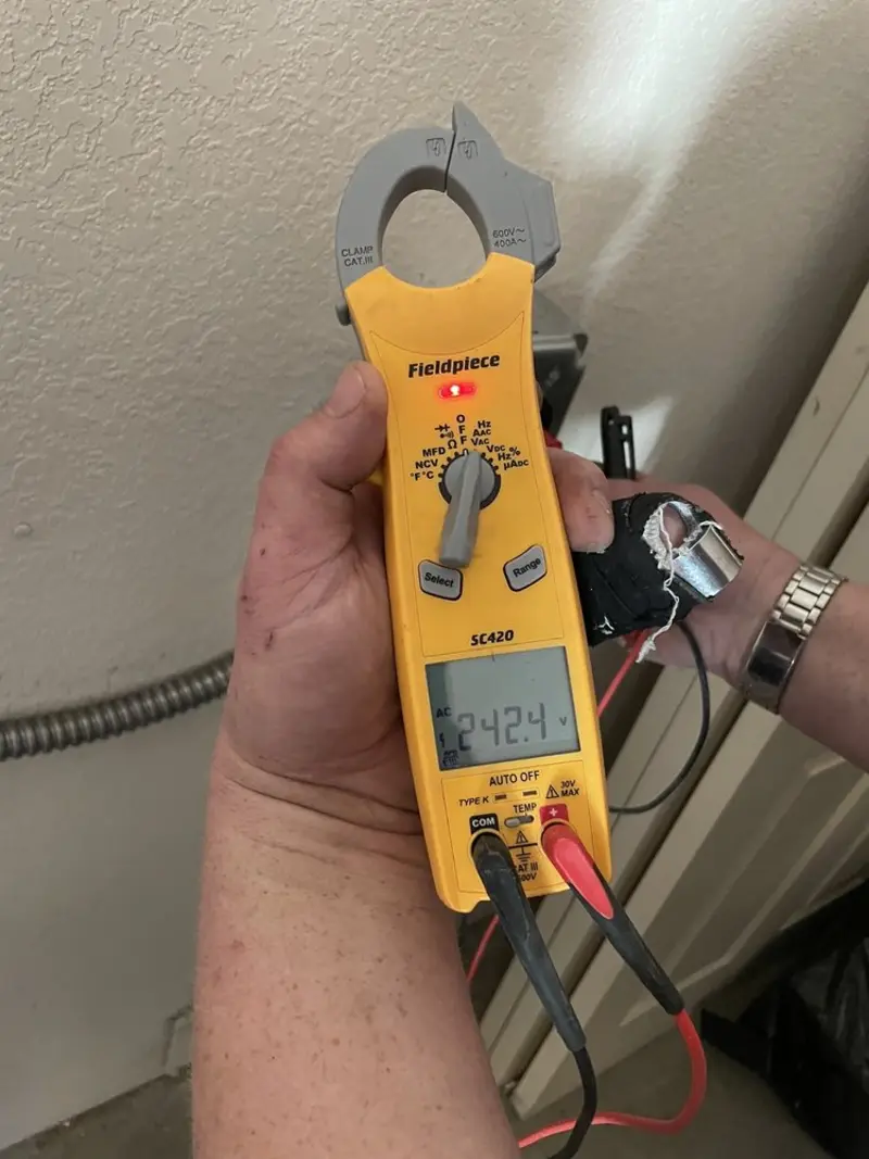 Voltage testing with clamp meter during Ceiling Fan Installation in Saranac Lake